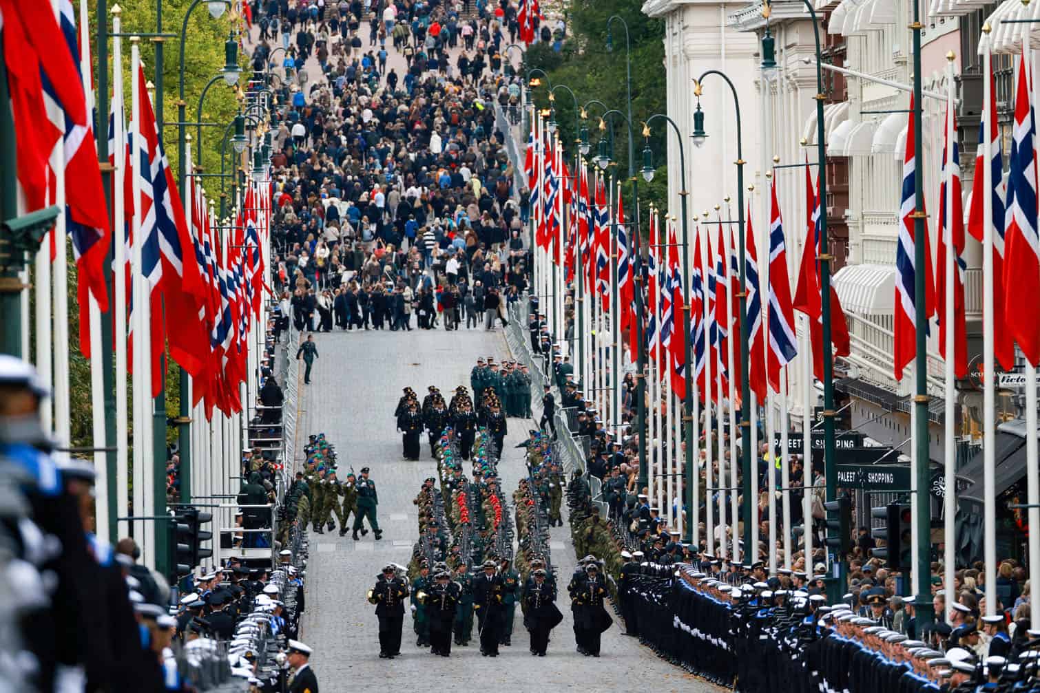 Members of the armed forces march while spectators (back) flock towards the Royal Palace to greet members of the royal family in Oslo, Norway, on September 9, 2026 after Norway's late King Harald V was laid to rest at Akershus Castle. (Photo by Hans Olav Torgersen / NTB / AFP)