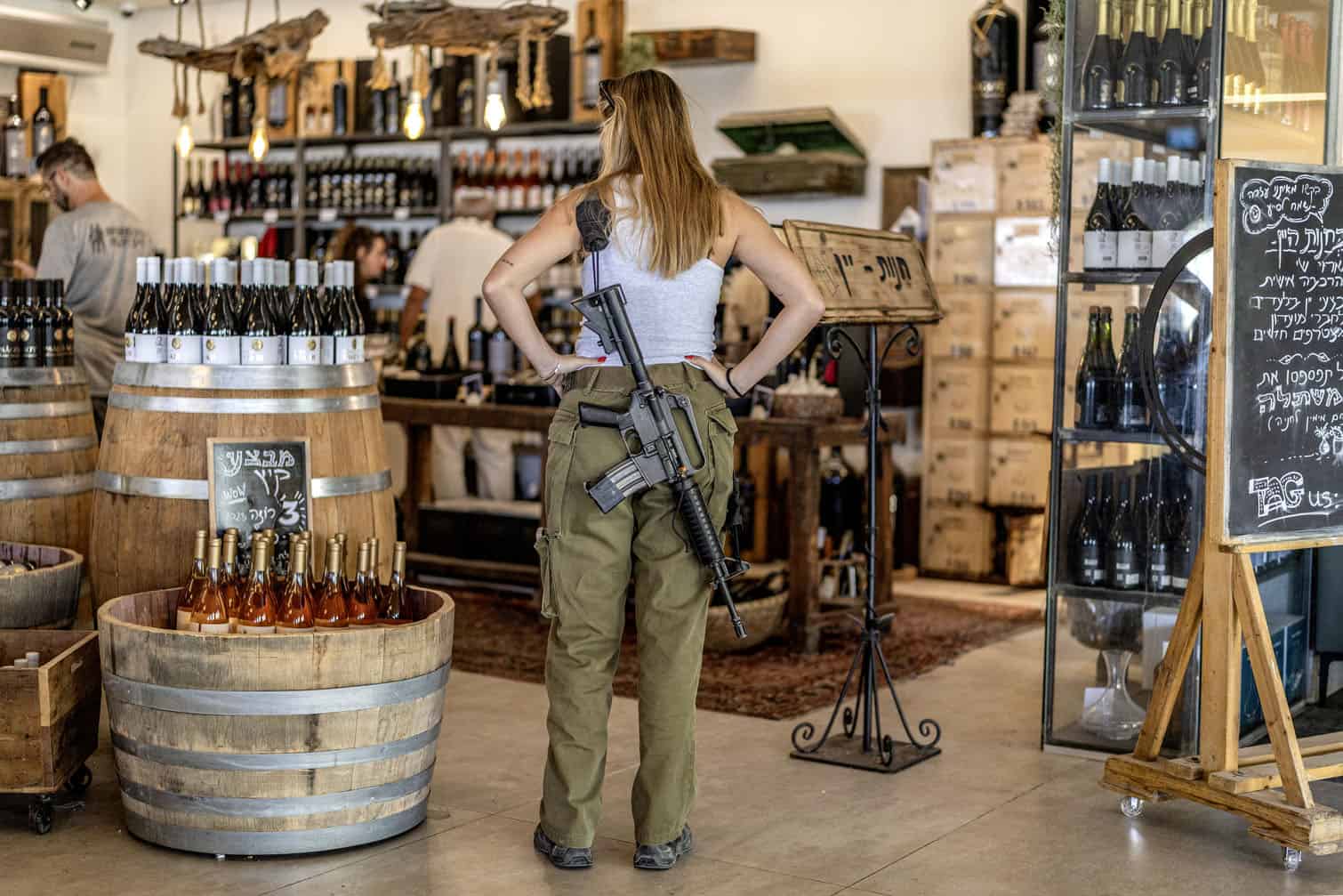 An Israeli army soldier stands at a winery facility in the Israeli settlement of Sha'ar Binyamin in the occupied West Bank southeast of Ramallah on September 9, 2026. (Photo by Ilia YEFIMOVICH / AFP)