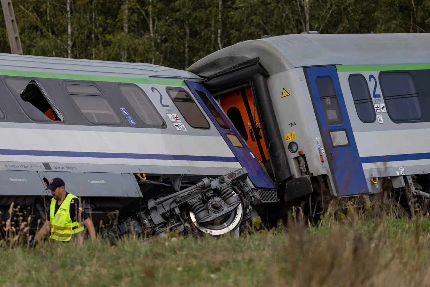 Police officers, firefighters and investigators work at the site where a passenger train collided with a lorry at a level crossing in the village of Sokolniki Suche, south-eastern Poland on September 9, 2026. A train carrying 120 passengers collided with a cement truck and derailed in east-central Poland, killing one passenger and leaving several injured, local authorities said Wednesday. (Photo by Wojtek RADWANSKI / AFP)