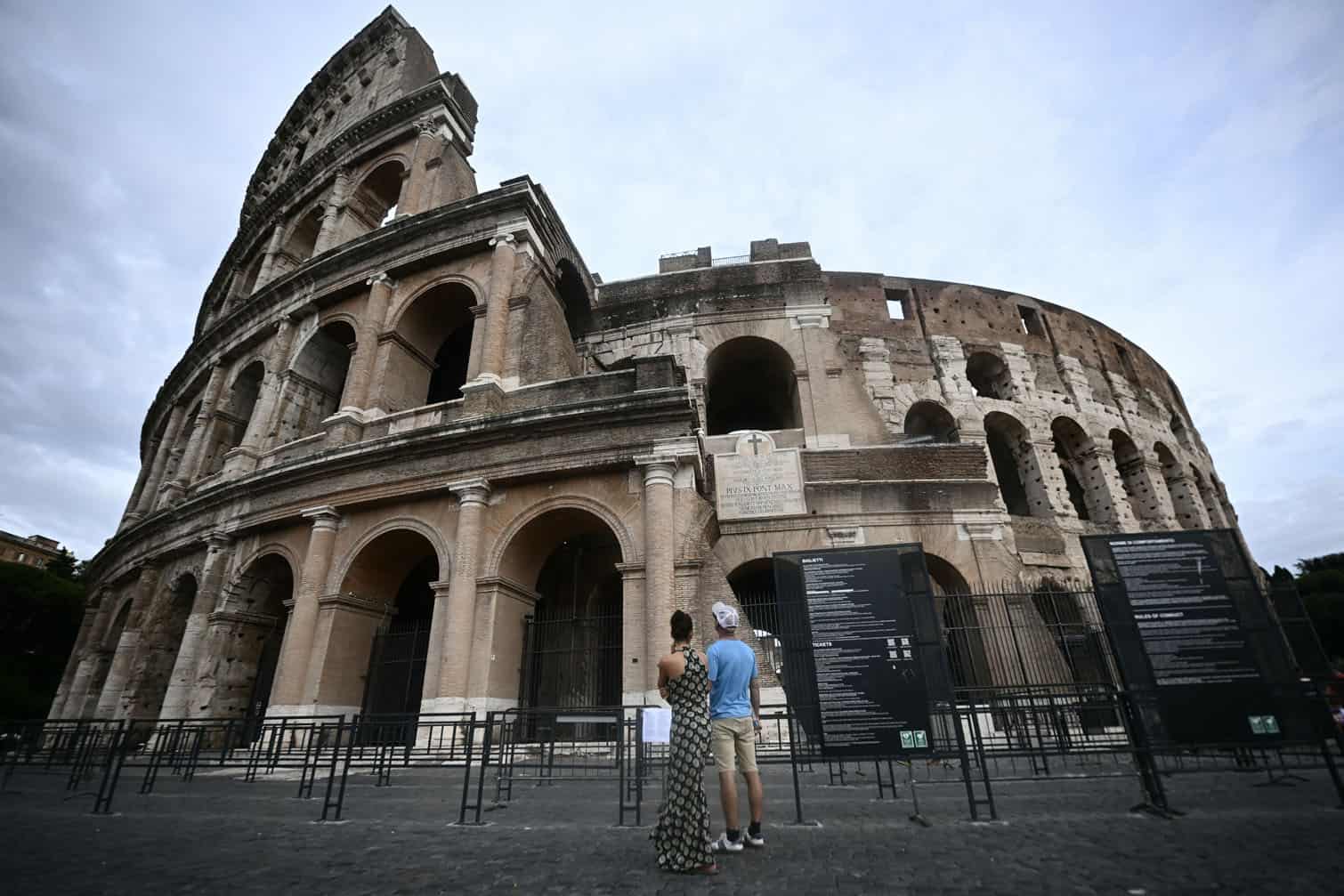 People stand outside the Colosseum, which remains closed a day after a worker’s death on September 24, 2026. Andrea Moretti, 22, reportedly died after falling from a height while working on a new lighting installation at night on September 23, 2026. (Photo by Filippo MONTEFORTE / AFP)