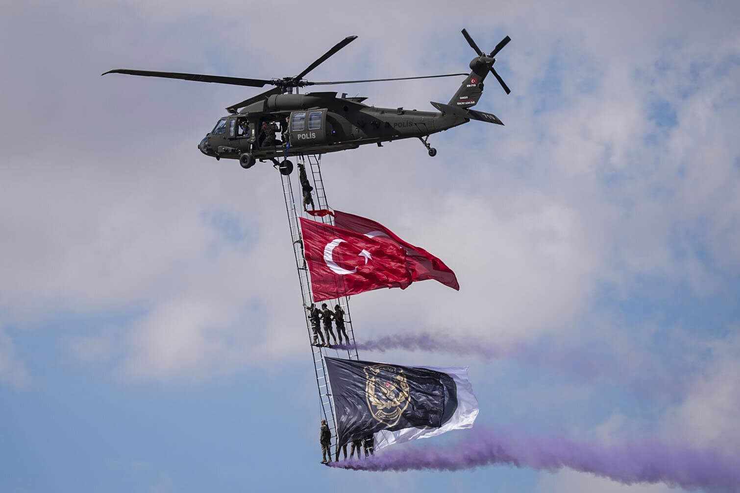 Turkish Special Operations police officers conduct a flypast with the flag on an S-70 helicopter during TEKNOFEST Southeast, world's largest aviation, space, and technology festival at the Sanliurfa GAP Airport for its 15th edition in Sanliurfa, Turkiye on September 30, 2026. (Photo by Agit Erdi Ulukaya/Anadolu via Getty Images)