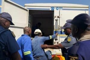 Workers are escorted by officials during the multidisciplinary inspection led by Deputy Minister Jomo Sibiya and Executive Mayor Dada Morero.