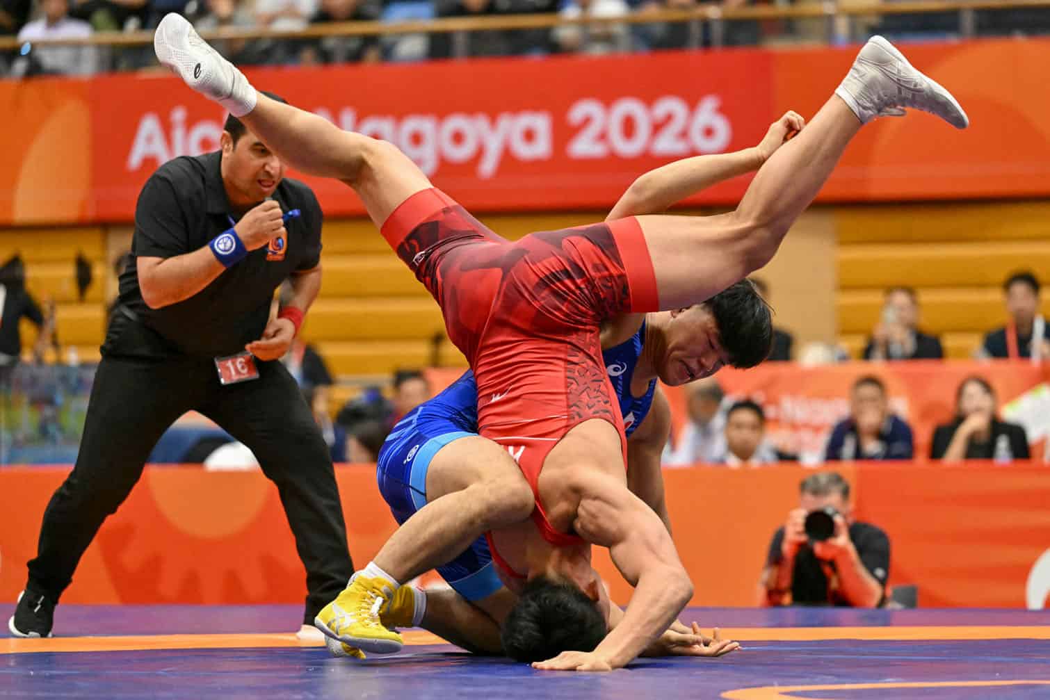 Japan's Taizo Yoshida (R) competes with Kyrgyzstan's Asan Kurbanovich Zhanyshov in the men's Greco-Roman 87kg final match of the wrestling event during the 2026 Asian Games at the Inae Sports Center in Nagoya on September 30, 2026. (Photo by MOHD RASFAN / AFP)
