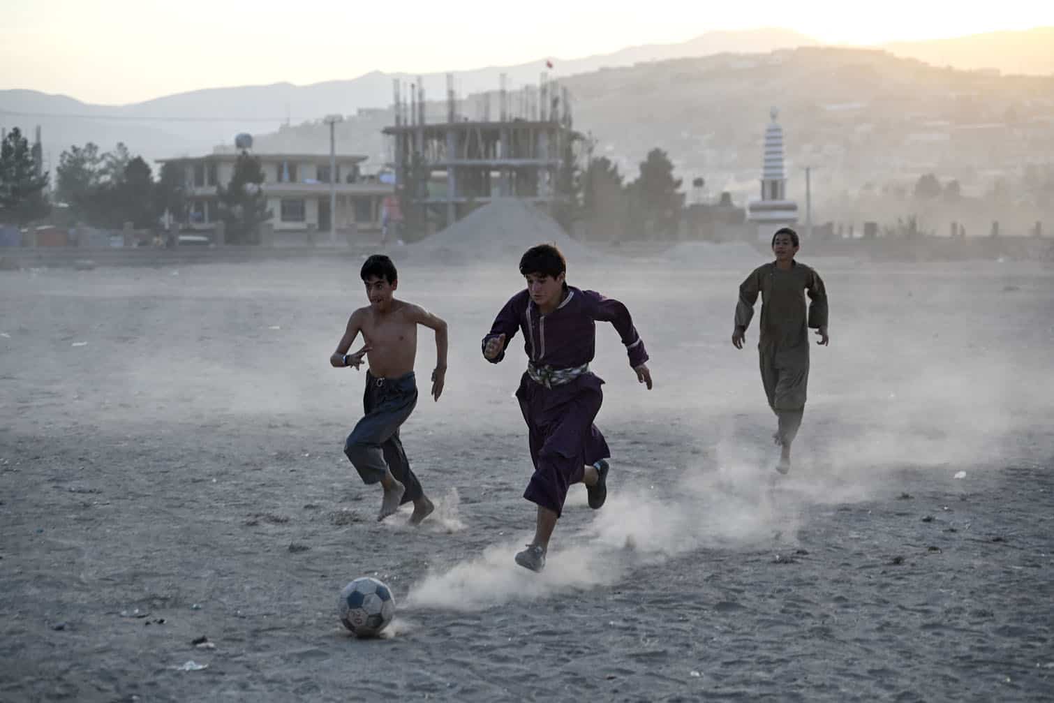 Afghan boys play football on a field in Fayzabad district of Afghanistan's Badakhshan province on September 30, 2026. (Photo by Omer ABRAR / AFP)