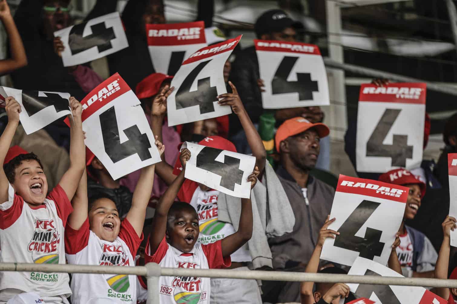 Young cricket supporters celebrate after South Africa's Aiden Markram made four runs on day one of the second Test match between South Africa and Australia at St Georges Park in Gqeberha on October 18, 2026. (Photo by Marco Longari / AFP)