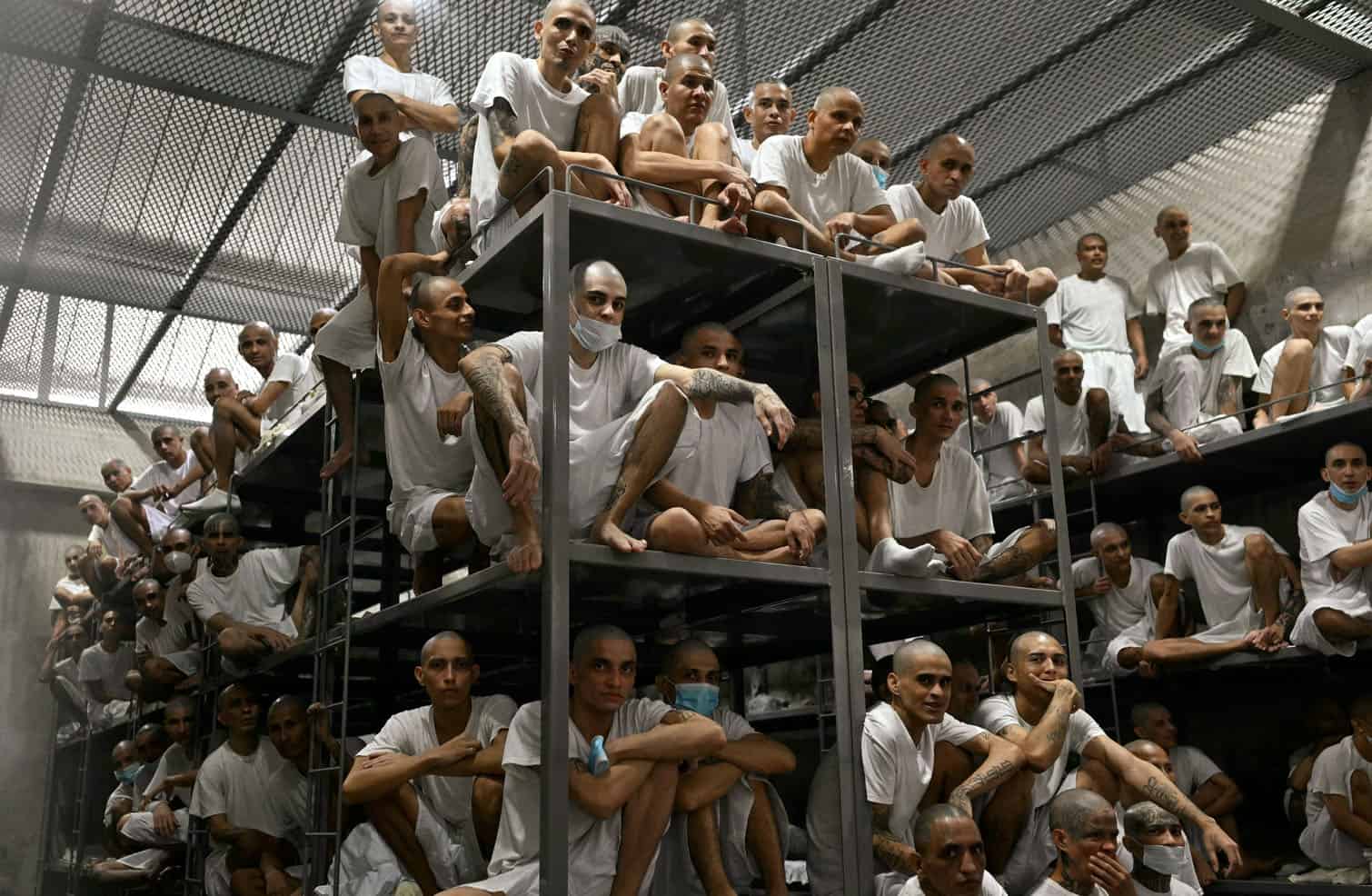 Inmates are pictured during a visit of Costa Rica's President Laura Fernandez at the CECOT prison in Tecoluca, El Salvador on October 16, 2026. Costa Rica opened a high-security jail on October 15, 2026, inspired by a mega-prison in El Salvador that has become a symbol of the country's war on gangs, widely criticized by human rights groups. (Photo by Marvin RECINOS / AFP)