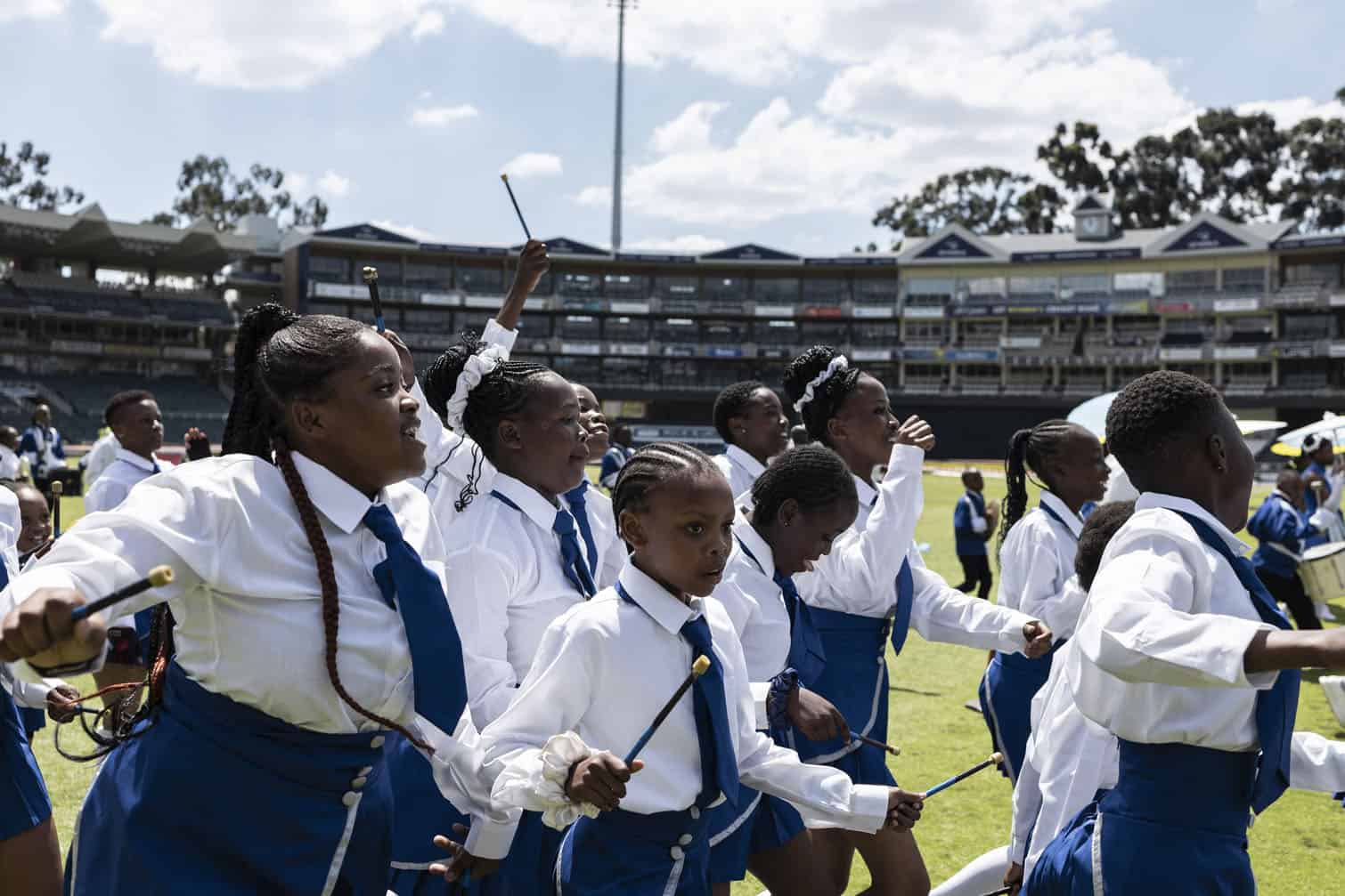 Members of the Alexandra Field Band run off the field after their performance at the Field Band Foundation’s National Championships at Wanderers Stadium in Johannesburg on October 3, 2026. (Photo by ILARIA FINIZIO / AFP)