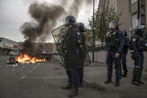 Riot police officers stand guard