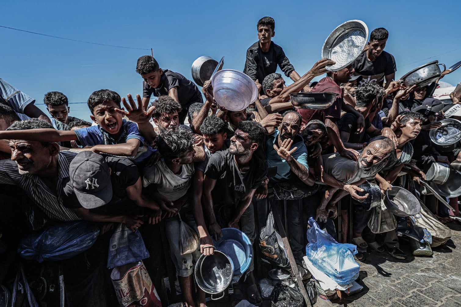 Palestinians gather to receive free meals from a charitable soup kitchen in Khan Younis, in the southern Gaza Strip, on September 23, 2026. Amid ongoing shortages and difficult living conditions, displaced Palestinians rely on charitable kitchens and food distributions for daily meals. (Photo by Omar Ashtawy/Getty Images)