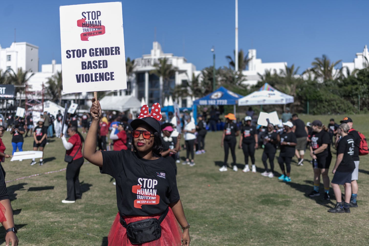 An activist against human trafficking and gender-based violence holds a banner during a 5km walk along the promenade in Durban, 3 October 2026, under the theme “One Voice, One Fight: End Human Trafficking”. The walk was organised by the Umgeni Community Empowerment Centre (UCEC), with support from students of Durban University of Technology (DUT) and several partner organisations. It formed part of a day of awareness activities, including talks, food vendors and community events. Picture: Rajesh Jantilal