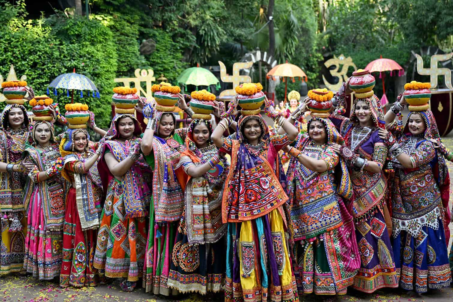 People in traditional dresses take part in a 'Garba' practice session ahead of the Hindu festival of Navaratri in Ahmedabad on October 4, 2026. (Photo by Shammi MEHRA / AFP)