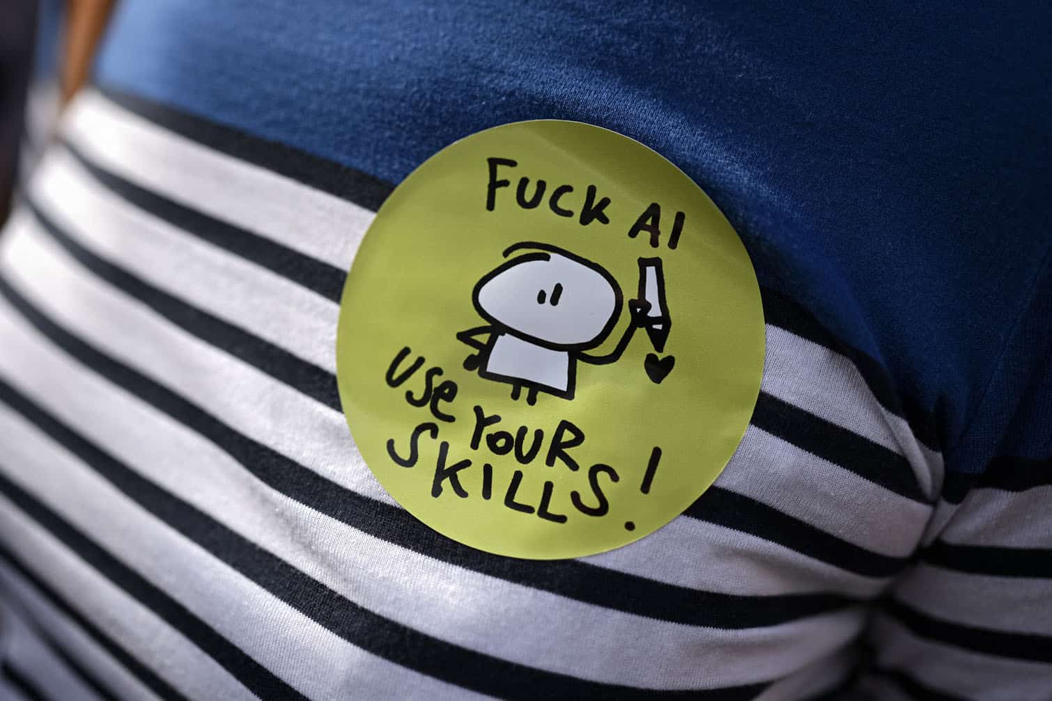 A demonstrator wearing a sticker reading