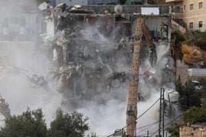 Israeli forces demolish a residential building
