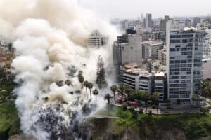 smoke rising from a fire on the Costa Verde cliffs