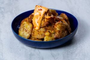 Smashed Baby Potatoes with chilli, thyme and a dynamite sauce recipe