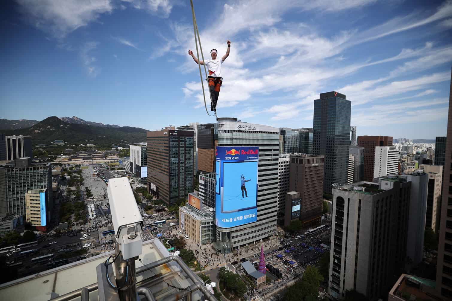 Estonia's Jaan Roose performs on a slackline during South Korea's first urban highline crossing event, 160 metres long and suspended 120 metres above the ground, in central Seoul on October 1, 2026. (Photo by KIM HONG-JI / POOL / AFP)