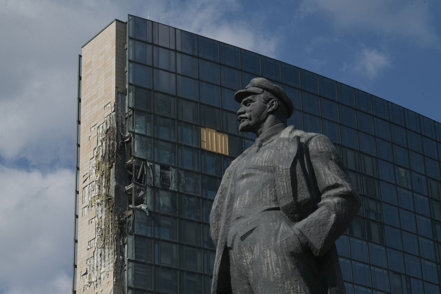 A monument of the Soviet Union founder Vladimir Lenin sits in front of a damaged business centre following an overnight attack, which local Russian-installed officials called a Ukrainian drone strike, in Donetsk, Russian-controlled Ukraine, on October 5, 2026, amid the ongoing Russian-Ukrainian conflict. (Photo by AFP)